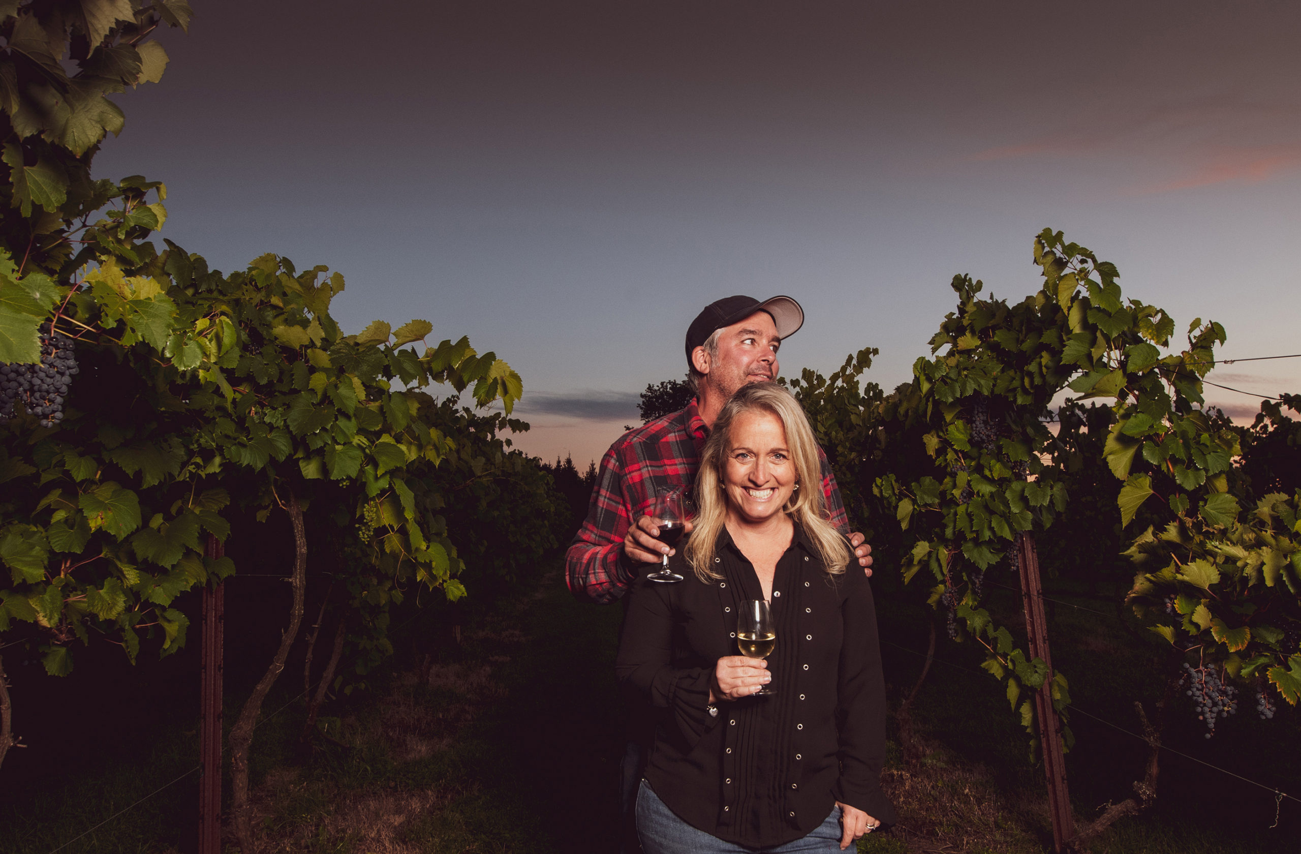 Teresa and Scott standing in their vineyard