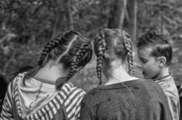 Two girls in braids and a boy with a cool hairdo