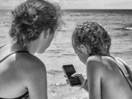 Young girls at the beach and on their phones