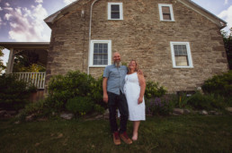 Mike and Sandra pose in front of their historic home in Vankleek Hill.