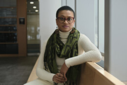 A female is seted looking out a window